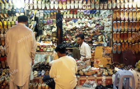 a shoe shop the souq or Market in the old town in the city of Dubai in the Arab Emirates in the Gulf of Arabia.