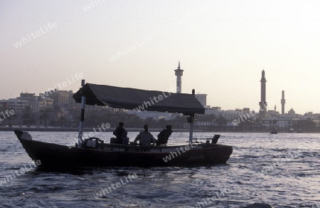 a city boat and ferry on the Dubai creek in the old town in the city of Dubai in the Arab Emirates in the Gulf of Arabia.