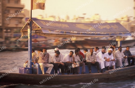 a city boat and ferry on the Dubai creek in the old town in the city of Dubai in the Arab Emirates in the Gulf of Arabia.