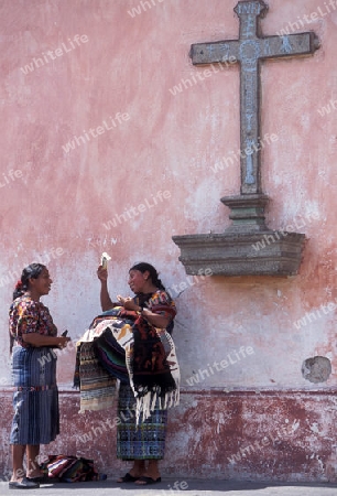  indio women in the old town in the city of Antigua in Guatemala in central America.   