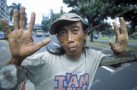 a men working in the city centre of Jakarta in Indonesia in Southeastasia.