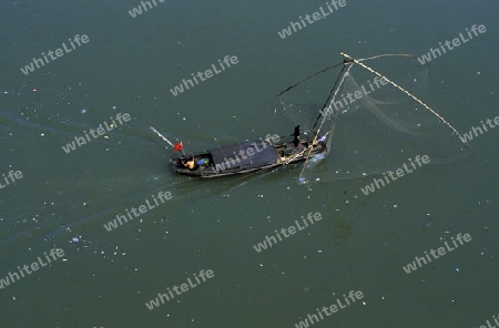 a fishing boatin the yangzee river in the city of yichang near the three gorges dam project in the province of hubei in china.