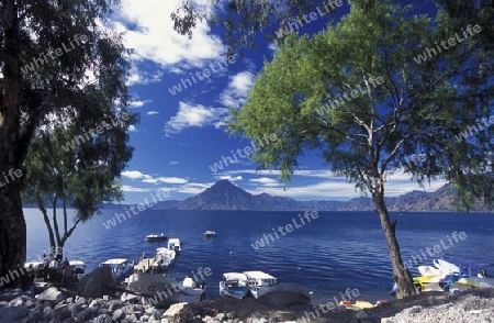 The Lake Atitlan mit the Volcanos of Toliman and San Pedro in the back at the Town of Panajachel in Guatemala in central America.   