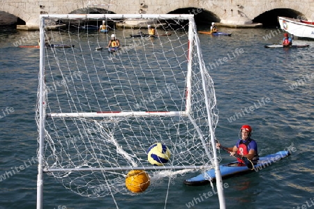 a Water Kanu Ball Game in the Harbour in the old town of Siracusa in Sicily in south Italy in Europe.