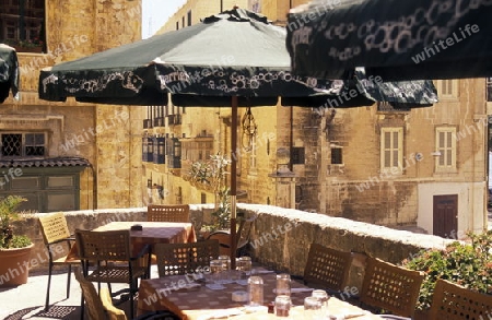 A smal road in the centre of the Old Town of the city of Valletta on the Island of Malta in the Mediterranean Sea in Europe.
