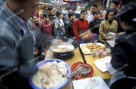 people in a fastfood restaurant on the Market streets of Chongqing in the province of Sichuan in china in east asia. 