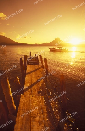 The Lake Atitlan mit the Volcanos of Toliman and San Pedro in the back at the Town of Panajachel in Guatemala in central America.   