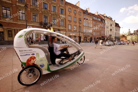 A Electro Taxi in the Old Town in the City of Warsaw in Poland, East Europe.