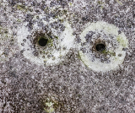 Detailed close up of bullet holes from gun shots in a german traffic sign