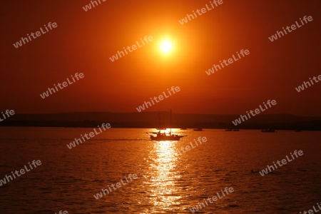 a Sunset at the old Town of Siracusa in Sicily in south Italy in Europe.