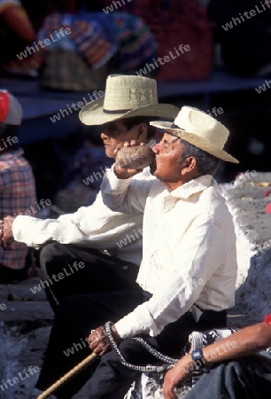 people in traditional clotes at the Market in the Village of  Chichi or Chichicastenango in Guatemala in central America.   