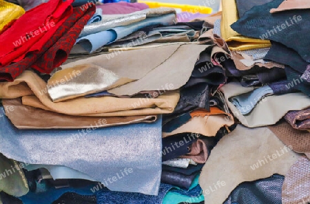 Detailed close up view on samples of cloth and fabrics in different colors found at a fabrics market.