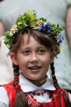 a Women in traditional dress on a Summer Festival in a Parc in the old City of Vilnius in the Baltic State of Lithuania,  