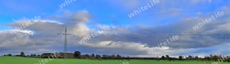 Beautiful high resolution panorama of a northern european country landscape with fields and green grass.