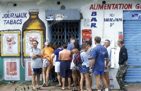 people go shoping bevor a tropical storm in the town of  St Gilles les Bains  on the Island of La Reunion in the Indian Ocean in Africa.