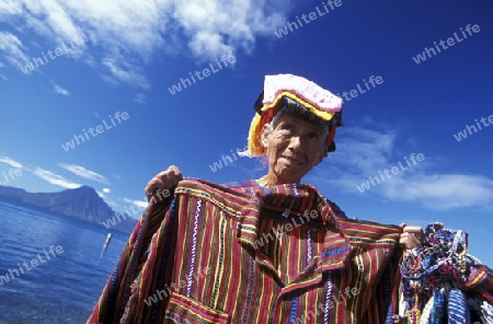 People at the coast of Lake Atitlan mit the Volcanos of Toliman and San Pedro in the back at the Town of Panajachel in Guatemala in central America.   