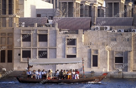 a city boat and ferry on the Dubai creek in the old town in the city of Dubai in the Arab Emirates in the Gulf of Arabia.