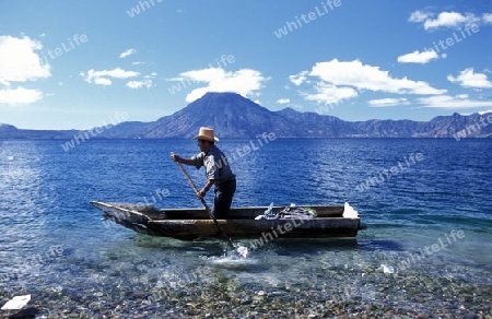 The Lake Atitlan mit the Volcanos of Toliman and San Pedro in the back at the Town of Panajachel in Guatemala in central America.   