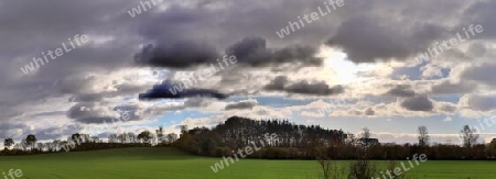 Beautiful high resolution panorama of a northern european country landscape with fields and green grass.