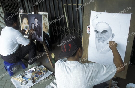 artist painter at working in a shop in the city centre of Jakarta in Indonesia in Southeastasia.