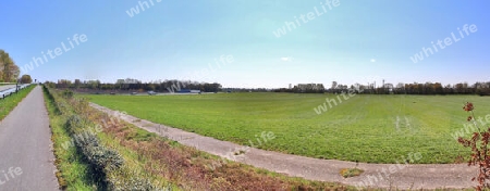 Beautiful high resolution panorama of a northern european country landscape with fields and green grass.