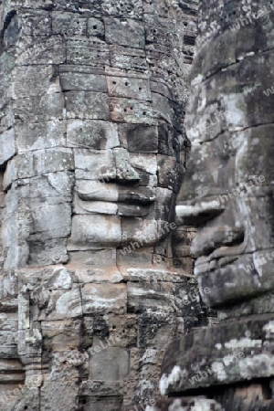 Stone Faces the Tempel Ruin of Angkor Thom in the Temple City of Angkor near the City of Siem Riep in the west of Cambodia.